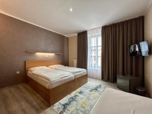 Postel nebo postele na pokoji v ubytování Hotel Roháč
