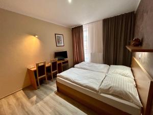 Postel nebo postele na pokoji v ubytování Hotel Roháč