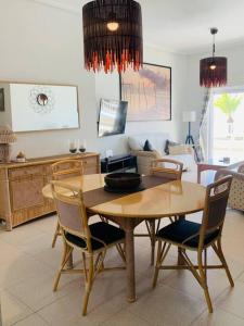 a dining room table and chairs in a living room at Cabo Romano, 3 Bedroom,2 Bathroom Apartment with Sea Views LMHA 14 in La Manga del Mar Menor