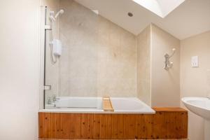 a bathroom with a bath tub and a sink at The Shed in Durham