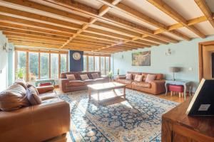 a large living room with couches and a table at The Shed in Durham