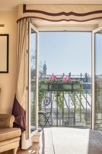 a bedroom with a bed and a large window at Castille Paris – Starhotels Collezione in Paris