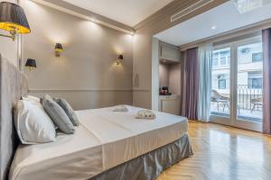 a bedroom with a large bed and a balcony at Belle Boutique in Sliema