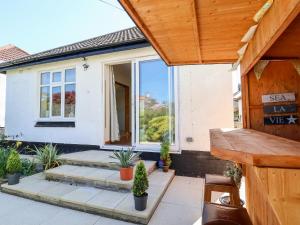 a patio with potted plants in front of a house at 3 Rhyd Drive in Colwyn Bay