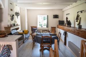 a living room with a table and a couch at Josette in Asquins