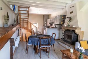 a living room with a table and a fireplace at Josette in Asquins