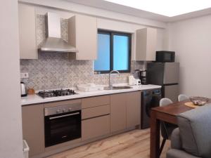 a kitchen with a sink and a stove top oven at Elegant and comfy apartment in Westlands, Nairobi in Nairobi