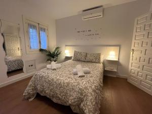 a bedroom with a bed with two pillows on it at Casa El Cerro in Cortes de la Frontera