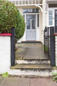 a front door of a house with a gate at Modern Private Studio Room in London