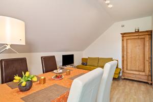 a living room with a table and a couch at Haus Barbara, Ferienwohnung, 90qm in Unterreitnau