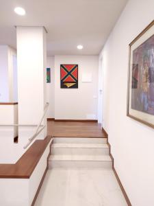 a staircase in a house with a painting on the wall at Rho Mind Villa in Rho