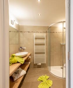 a bathroom with a sink and a shower at Hotel Meinhardt in Schenna