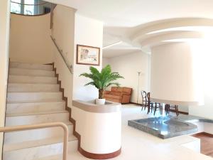 a staircase in a living room with a potted plant at Rho Mind Villa in Rho
