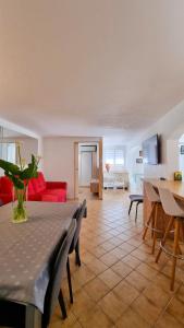 a living room with a table and a red couch at Dolce Apartment 3 Bedrooms for 5 people 10 minutes from Cannes in Mandelieu-la-Napoule