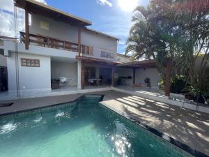a swimming pool in front of a house at Casa Malta Goiânia in Goiânia