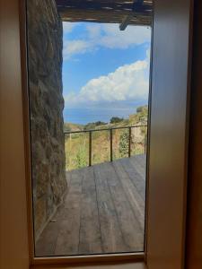 a view from a door looking out onto a deck at KLIDON Dreamy Living Suites in Mýkonos City