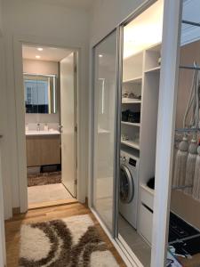 a laundry room with a washer and dryer next to a bathroom at Belgrade Waterfront Wolf in Sajmište +14 photos