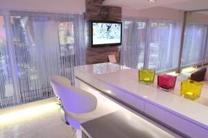 a room with a table and chairs and a tv at NICE LIFE - Luxury apartment in the Old Town. in Bratislava +22 photos