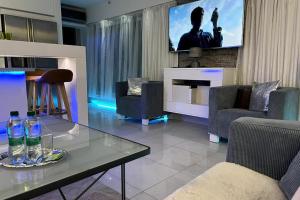 a living room with a glass table with bottles on it at NICE LIFE - Luxury apartment in the Old Town. in Bratislava