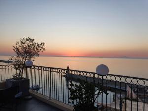 a view of the ocean at sunset from a balcony at Hôtel Des Gouverneurs in Bastia