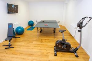 a gym with a ping pong table and exercise balls at B&B Plitvice Area Natura1 in Seliste Dreznicko