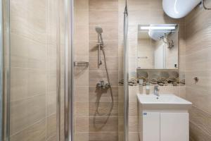 a bathroom with a shower and a sink at Labyrinth Apartment - free parking space included in Varna City +24 photos