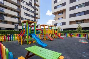 a playground in front of a tall building at Labyrinth Apartment - free parking space included in Varna City