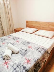 a bedroom with a bed with two towels on it at Marjanishvili Apartment in Tbilisi City