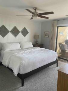 a bedroom with a bed and a ceiling fan at * The Dock Condo * Waterfront zen in Bluewater in Niceville