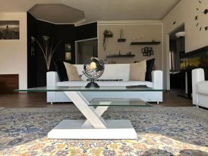 a living room with a glass table and a couch at Villa MA-YA in Santa Maria Imbaro
