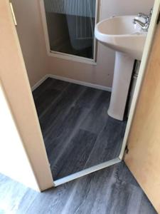 a bathroom with a sink and a mirror at TP52 in Skegness