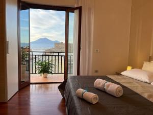 a bedroom with a bed and a balcony with a view at Vip sul mare in Castellammare di Stabia