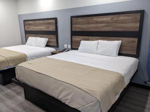 Postel nebo postele na pokoji v ubytování Captain Suites
