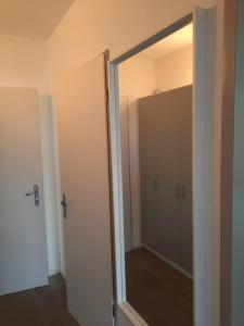a bathroom with a glass door to a closet at Haus Am Anger in Hangelsberg
