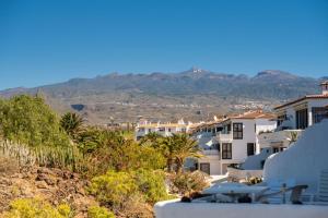 a view of a house with mountains in the background at Irina Beach Apartment in San Miguel de Abona