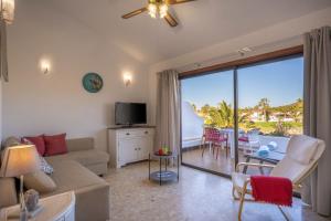 a living room with a couch and a view of a patio at Irina Beach Apartment in San Miguel de Abona