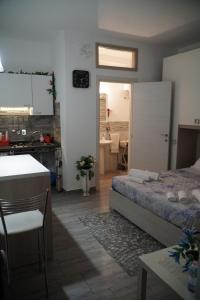 a bedroom with a bed and a kitchen with a sink at B&B porta Garibaldi in Catania