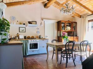 a kitchen with a table and chairs in a room at Effimera - Relaxing Retreat in Citta' Sant'Angelo