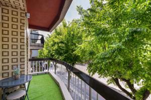 uma varanda com relva verde, uma mesa e árvores em Sé Apartamentos - Liberdade 546 Apartments em Braga