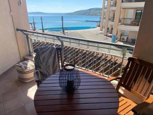 a bench on a balcony with a view of the ocean at Port Balchik apartment in Balchik