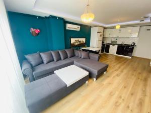 a living room with a couch and a table at Royal Loft Suit in Antalya