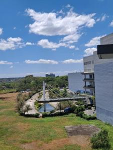 a bridge over a river next to a building at Amaia Steps Altaraza by GEMcondotel in Tunkong Manga
