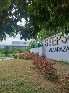 a sign for anarmaarmaarma plant with a building in the background at Amaia Steps Altaraza by GEMcondotel in Tunkong Manga
