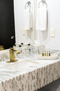 a white bathroom with a sink and a mirror at Hotel Posada San Antonio in Reynosa +65 photos