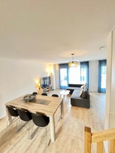 a living room with a table and a couch at Amsterdam - Bel appartement in Bezannes-les-Reims