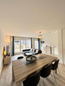 a living room with a large wooden table and chairs at Amsterdam - Bel appartement in Bezannes-les-Reims