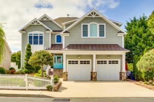 a house with two garage doors in a driveway at Spacious Ocean City Home - Walk to Beach! in Ocean City