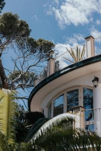 a building with a balcony on top of it at Hotel Atlantico in Castiglioncello