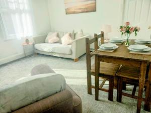 a living room with a table and a couch at Clock Tower Flats Morpeth in Morpeth