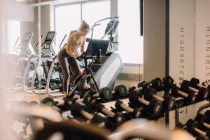 a woman riding a bike in a gym at San Jose Marriott in San Jose
